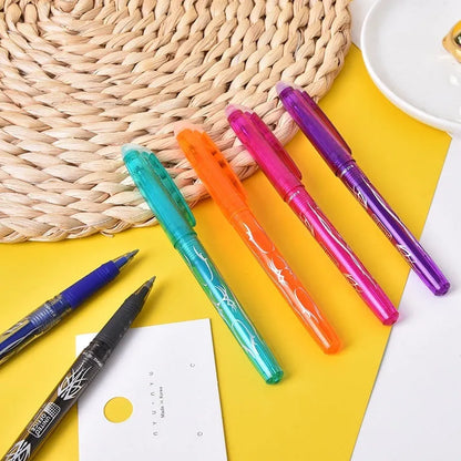 A set of hot erasable gel pens in multiple colours with plastic bodies and stainless steel nibs, shown with a hairdryer to illustrate the heat-erasable function.