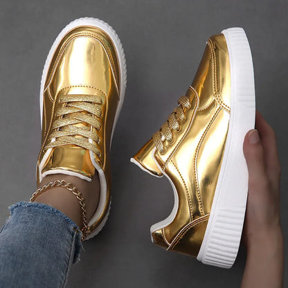 Rose gold and gold sequin platform sneakers with thick soles and round toe on a white background.