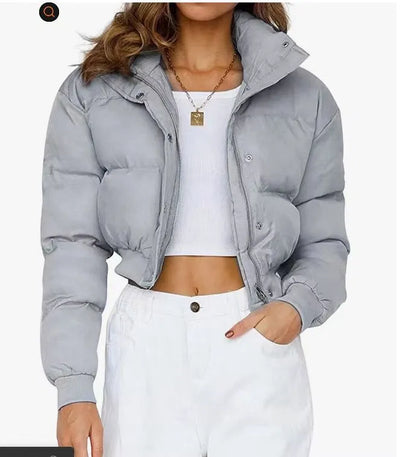 Women's loose-fit long sleeve polyester jacket in blue on a hanger.