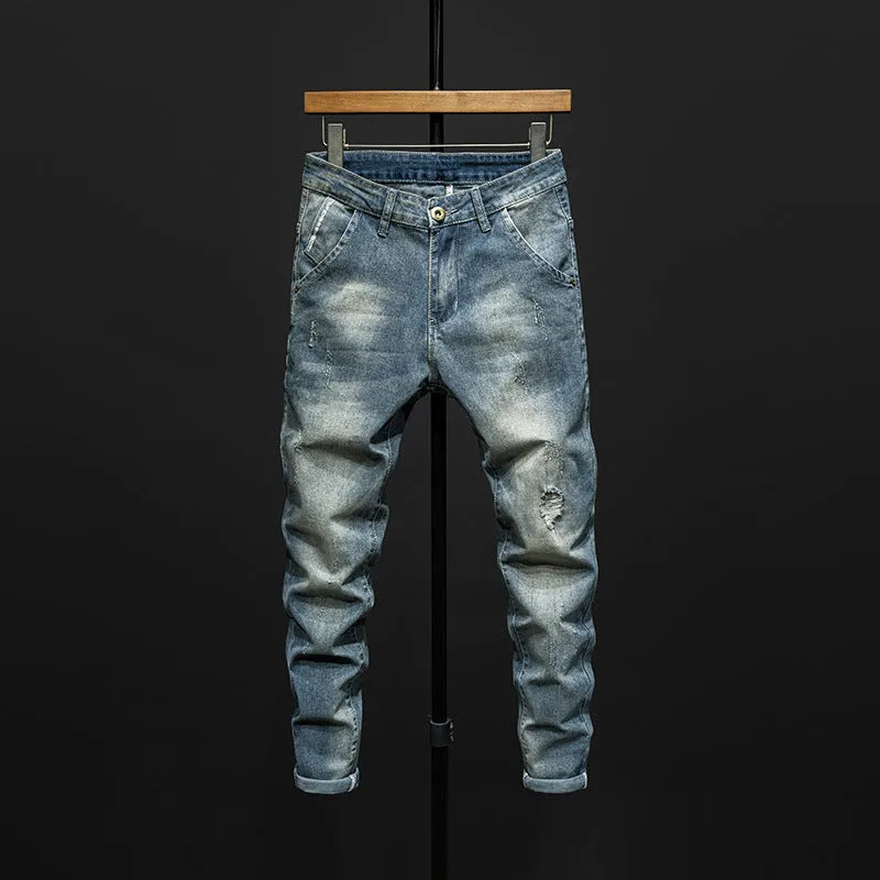 Men's slim-fitting dark blue denim jeans with micro-elasticity, mid-waist design, and standard trousers length on hanger