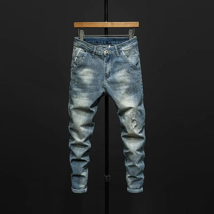 Men's slim-fitting dark blue denim jeans with micro-elasticity, mid-waist design, and standard trousers length on hanger