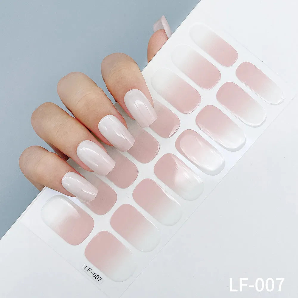 Sheet of 16 small design nail art stickers including cross, rose, tulip and marble patterns.