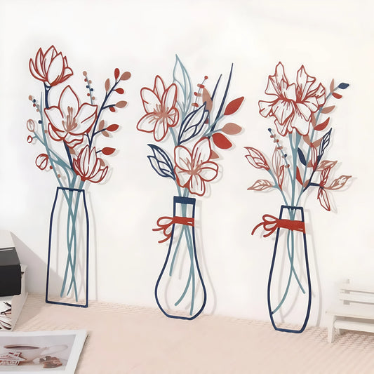 Set of three flat metal wall art pieces with stylised flower and vase designs in a rustic farmhouse style.