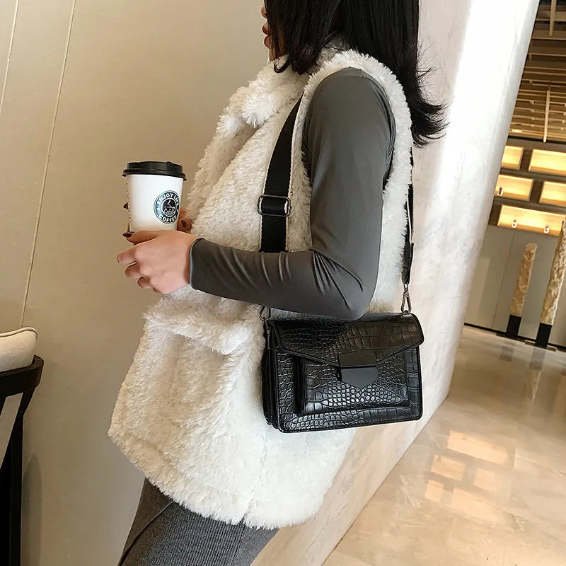 Vintage crossbody bag in black showing 20cm width, crossbody strap, and front storage compartment