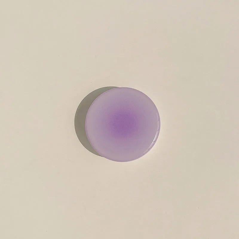 Yellow to purple gradient silicone iPhone case with a pop-out kickstand deployed.