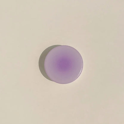 Yellow to purple gradient silicone iPhone case with a pop-out kickstand deployed.