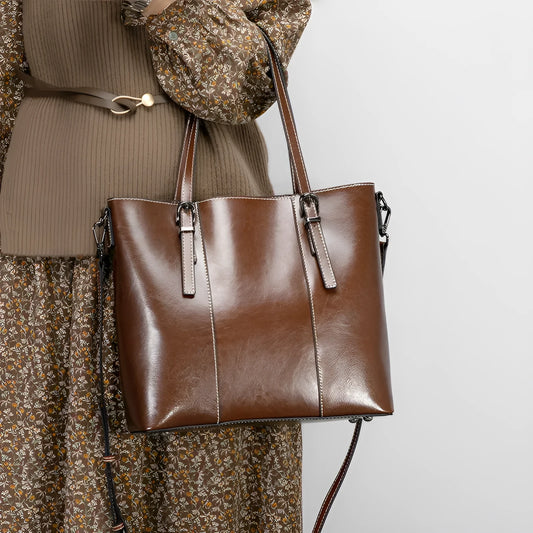 Brown genuine leather women's retro shoulder bag showing front view and organised interior pockets.