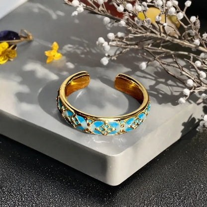 Adjustable copper gourd ring with zircon stones showing flower and bow design elements