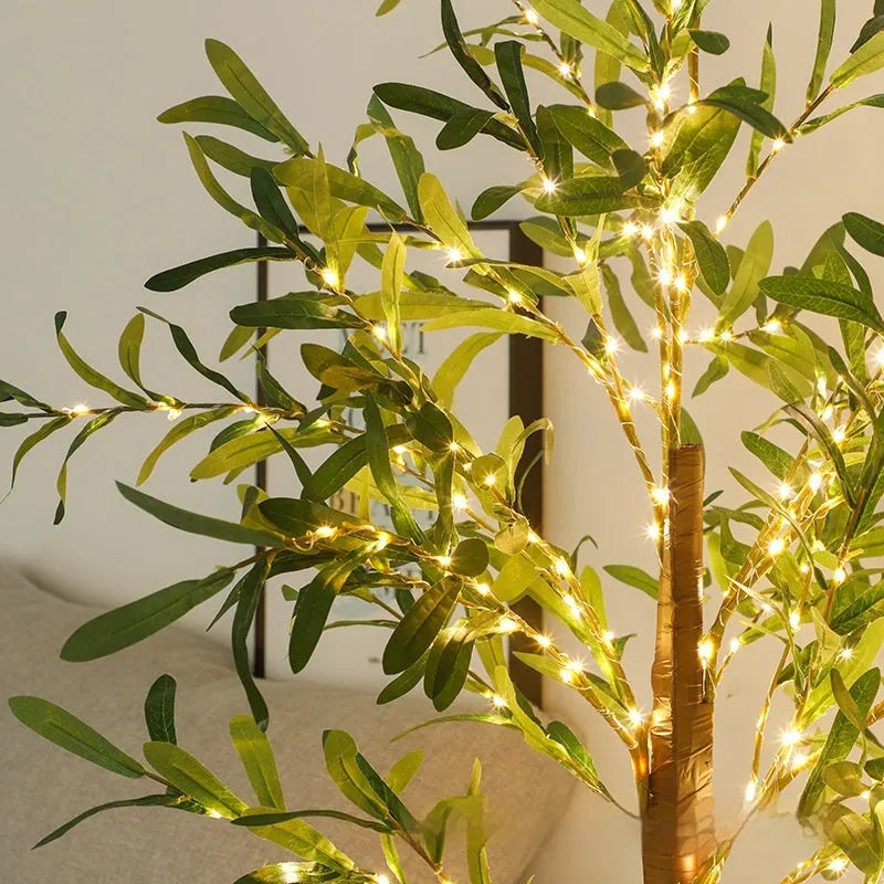1.8 metre tall artificial olive leaf tree lamp with warm white LED lights in courtyard setting