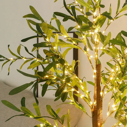 1.8 metre tall artificial olive leaf tree lamp with warm white LED lights in courtyard setting
