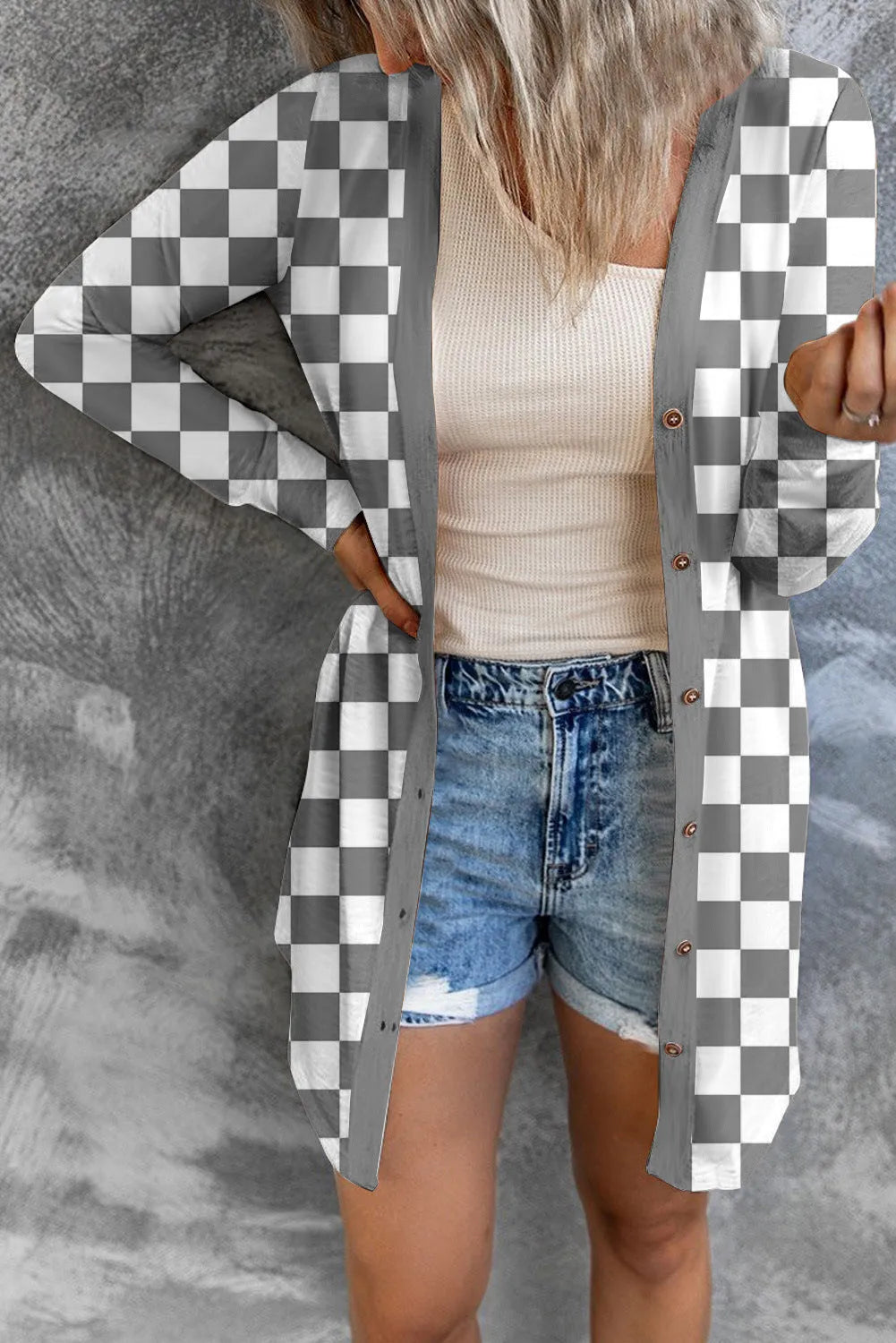 Women's long grey plaid knitted cardigan coat with loose fit and regular sleeves on a hanger