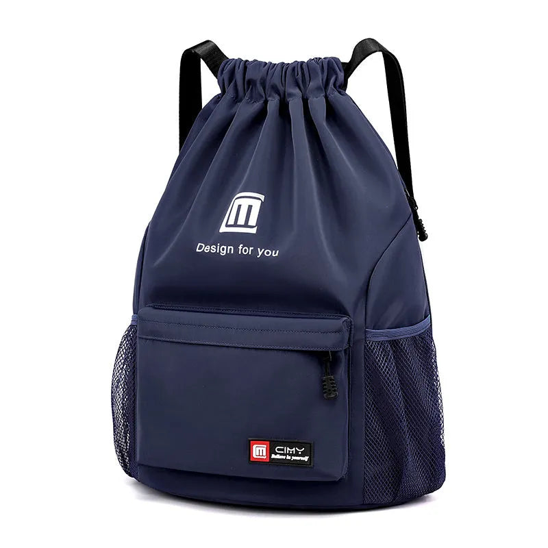 Large bucket-shaped travel backpack in blue with drawstring closure and soft black shoulder straps.