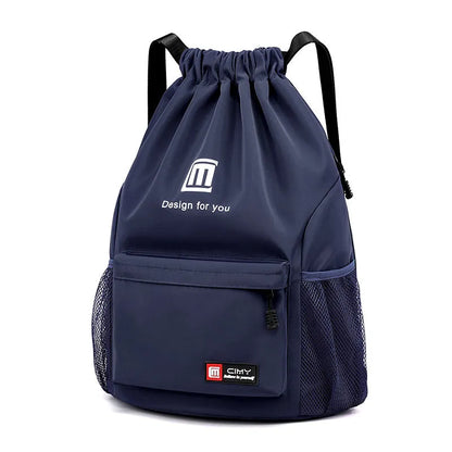 Large bucket-shaped travel backpack in blue with drawstring closure and soft black shoulder straps.