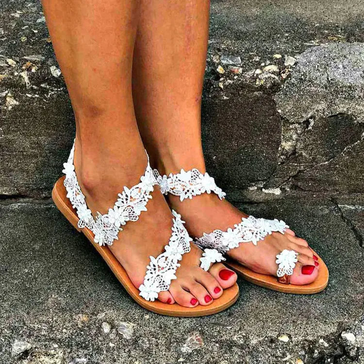 White women's flat shoes with rhinestone and floral embellishments on a patent leather PU upper, showing round toe and low back design.