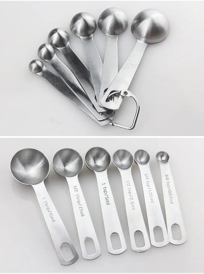 Six stainless steel measuring spoons with engraved markings and D-shape ring, sizes 1/8 tsp to 1 Tbsp