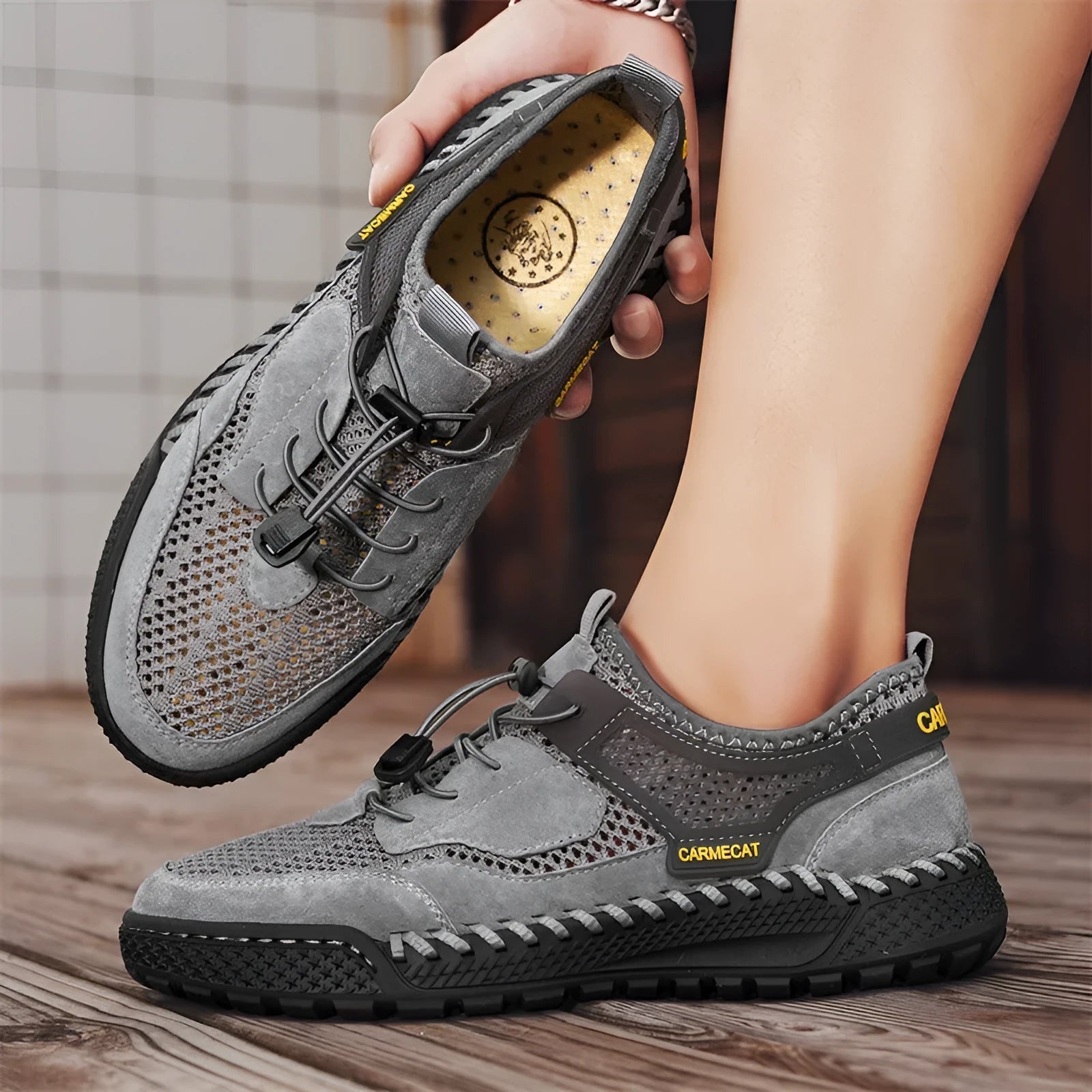 Men's brown suede casual tennis shoes with elastic band closure and hand-stitched rubber sole.