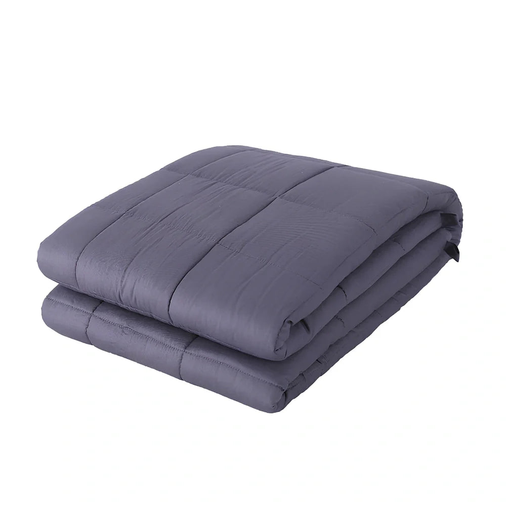 Weighted blanket with quilted compartments containing glass beads, available in dark grey, light grey, and navy colours