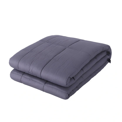 Weighted blanket with quilted compartments containing glass beads, available in dark grey, light grey, and navy colours