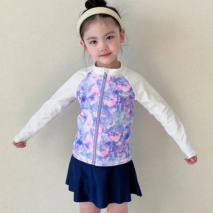 Girls' long sleeve swimsuit with split skirt in gradually varied pink colour, showing complete arm coverage and skirt design