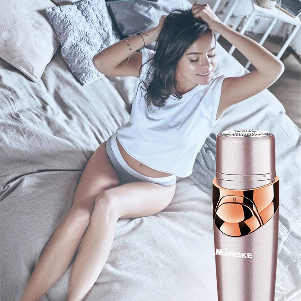 Four-in-one electric shaver in light fuchsia with USB charging cable and multiple cutter heads