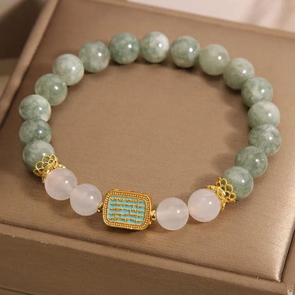 Women's bracelet with five oil green emerald crystal stones in a scripture charm design.
