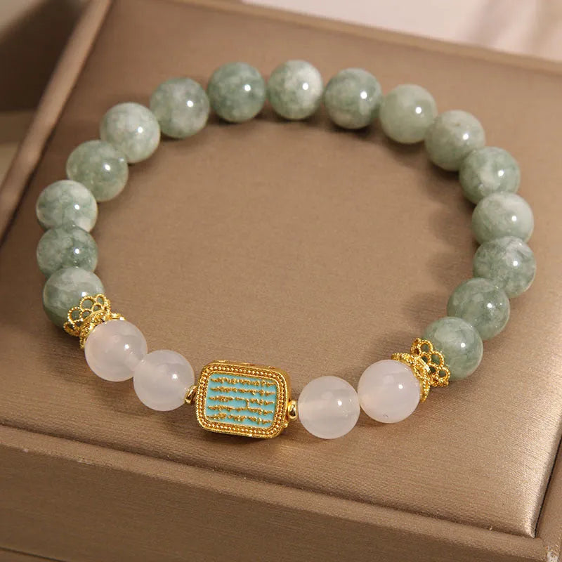 Crystal bracelet for women featuring five pieces of natural oil green emerald crystal stones set in a traditional sutra scripture charm design with a New Year theme and delicate construction.