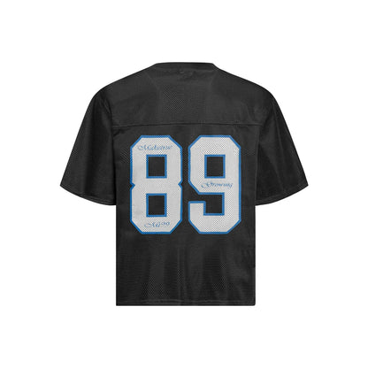 Man modelling a black loose-fitting T-shirt with a white alphanumeric graphic print on the chest.