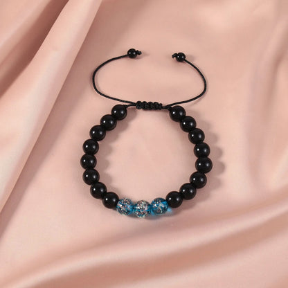 Adjustable bracelet with luminous geometric glass beads in six colour options on a wrist