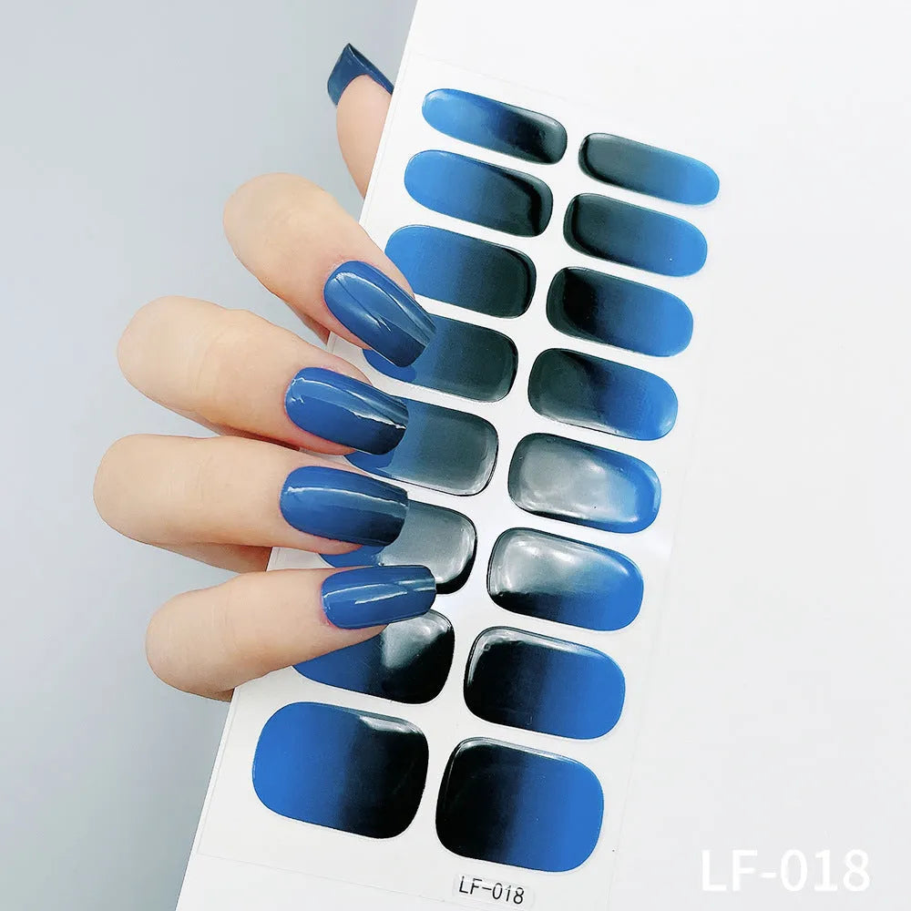 Sheet of 16 small design nail art stickers including cross, rose, tulip and marble patterns.