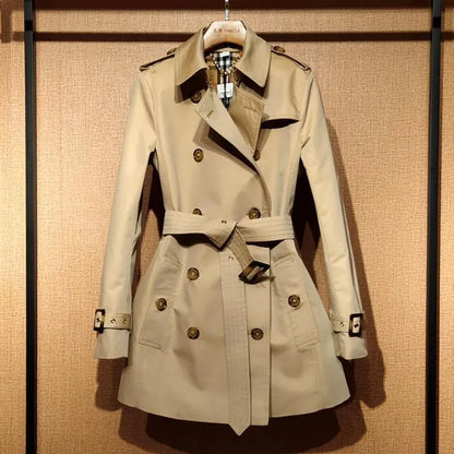 Khaki women's trench coat with double-breasted front and structured shoulder detailing