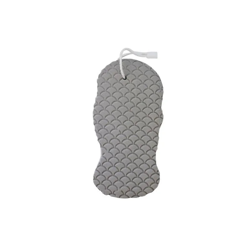 White 3D bath ball sponge with a fish scale exfoliating texture on a blue background.