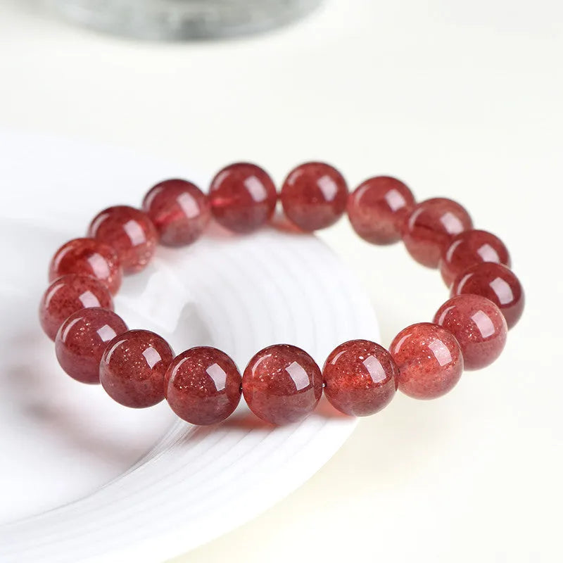 Strawberry quartz bracelet in natural starlight cherry red, unisex crystal jewellery with 5A or 3A grade polished stones, available in 10.8mm, 8.8mm, or 7.8mm bead sizes for adjustable wrist fit