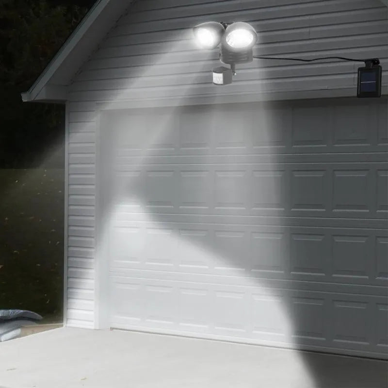 Black dual-head solar security spotlight with motion sensor for outdoor wall mounting