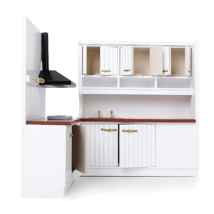 White two-piece dollhouse kitchen cabinet set with sink and stove units on a table.
