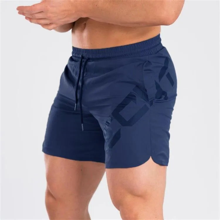 Men's black quick-dry training shorts with elastic waistband, shown knee-length.