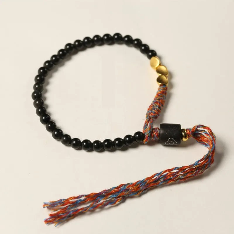 Hand-woven obsidian carrying strap showing woven texture and 4mm width