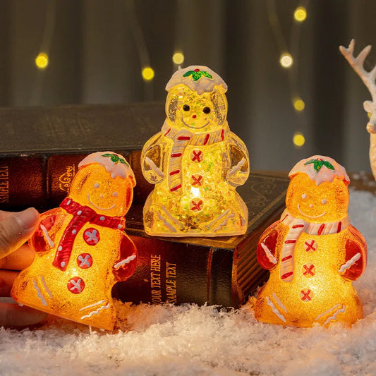 Glowing gingerbread man Christmas ornament measuring 6.5cm wide with LED lights and red scarf