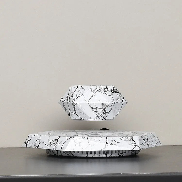 Marbling colour magnetic levitating plant pot floating above base with small plant inside