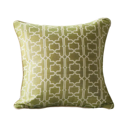 Square beige cushion cover with envelope closure on a grey sofa