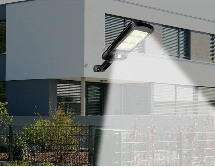 Black solar motion sensor security light for outdoor garden or fence installation with IP65 waterproof rating