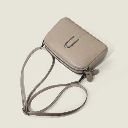 Minimalist top-grain leather crossbody bag in horizontal square shape with inner pockets, available in five colours