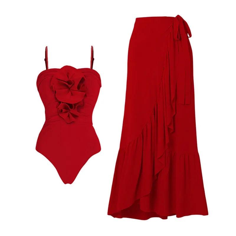 Red one-piece swimsuit with V-neck halter, open back, and a matching long skirt, with a detachable fabric flower.