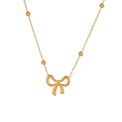 Gold titanium steel necklace with bow pendant on an adjustable cross chain, length 41cm to 50cm.