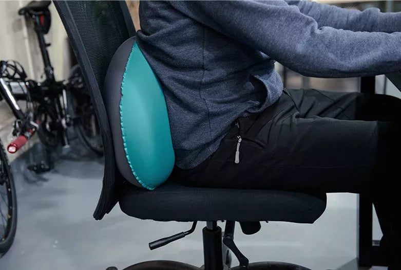 Compact inflatable travel pillow in peacock blue, bright orange, or green for camping and outdoor use