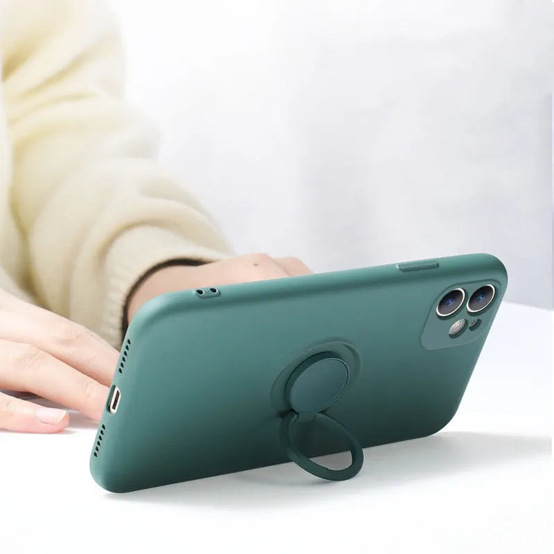 Liquid silicone case with rotating ring bracket for Apple iPhone 12 on a table, shown in green colour.