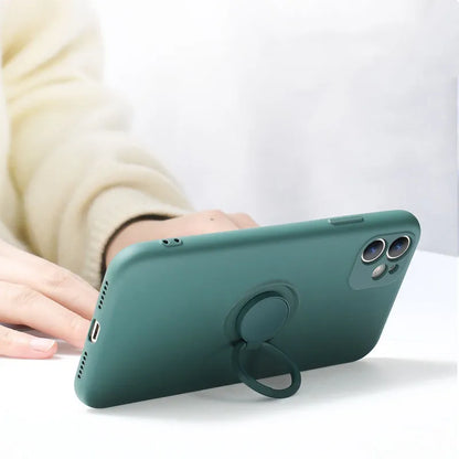 Liquid silicone case with rotating ring bracket for Apple iPhone 12 on a table, shown in green colour.