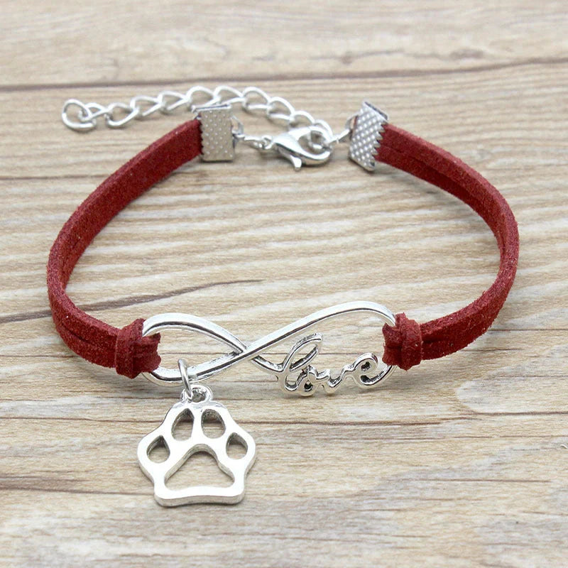 Hand-woven Infinite Love Pet Bracelet in various colors, showcasing the bow shape and alloy material.