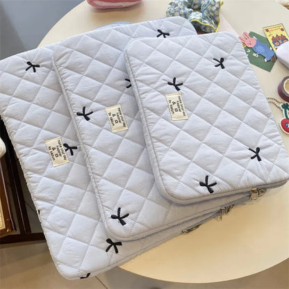 Nylon notebook storage bag with rhombus embroidery and bow, shown in light blue colour.