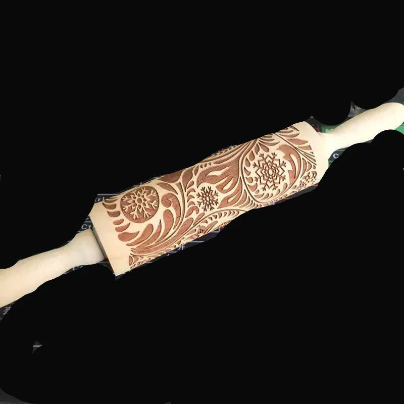 Wooden rolling pin with engraved Christmas patterns including reindeer and snowflakes on a 45cm long barrel.