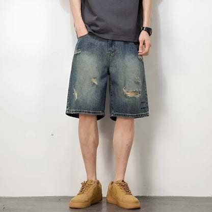 Men's blue distressed denim shorts with loose hole detailing and straight leg cut